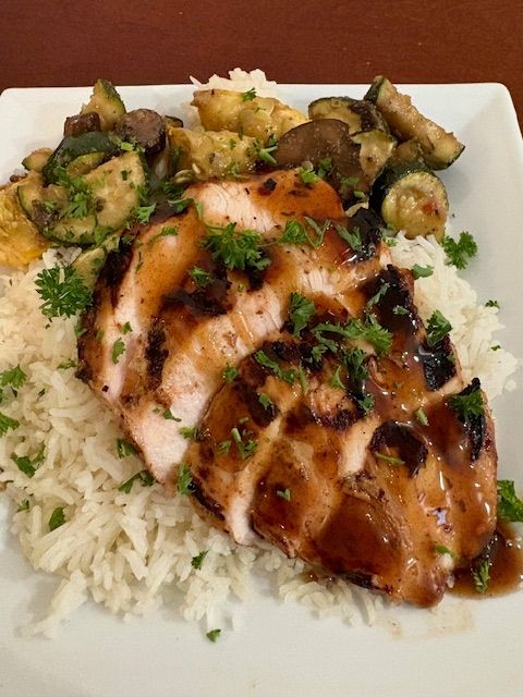 Spicy Caribbean jerk chicken grilled to perfection with bold island spices – served with rice and vegetables for a flavorful tropical meal  Grilled jerk chicken with natural spices and fresh sides – high-protein, low-fat Caribbean-inspired dish